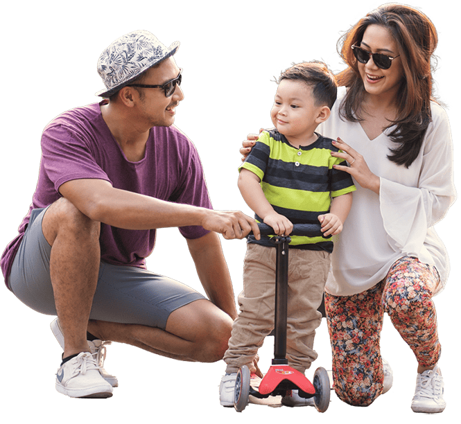 A Child Standing With Family on a Scooter